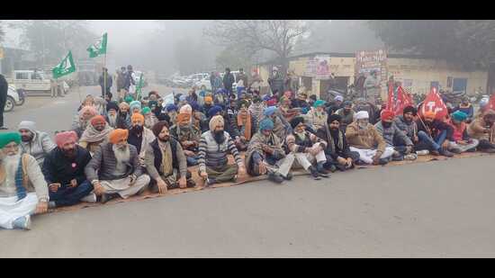 Farmers during a protest on a road in Ludhiana on Friday. (HT Photo)