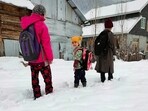 Children make their way on snow-covered road in the Gurez valley as the upper reaches of Jammu and Kashmir receives fresh snowfall, in Baramulla on Friday. Children make their way on snow-covered road in the Gurez valley as the upper reaches of Jammu and Kashmir receives fresh snowfall, in Baramulla on Friday.