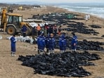 People work to clear spilled oil in Russia