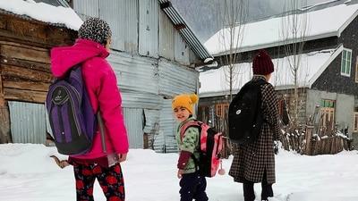 Children make their way on snow-covered road in the Gurez valley as the upper reaches of Jammu and Kashmir receives fresh snowfall, in Baramulla on Friday. (ANI) Children make their way on snow-covered road in the Gurez valley as the upper reaches of Jammu and Kashmir receives fresh snowfall, in Baramulla on Friday. (ANI)