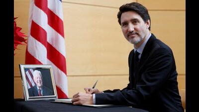 Canada's Prime Minister Justin Trudeau signs a book of condolences marking the passing of former US President Jimmy Carter at the US Embassy in Ottawa, Ontario, on Friday. (REUTERS)
