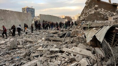 People and first responders inspect the rubble of a collapsed residential building that was hit by Israeli bombardment in the Saraya area in al-Rimal in central Gaza City on January 4, 2025 amid the ongoing war in the Palestinian territory between Israel and Hamas. (AFP) People and first responders inspect the rubble of a collapsed residential building that was hit by Israeli bombardment in the Saraya area in al-Rimal in central Gaza City on January 4, 2025 amid the ongoing war in the Palestinian territory between Israel and Hamas. (AFP)