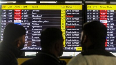Passengers look at the screens showing the arrival/departure time of flights at Indira Gandhi International Airport during a cold and foggy winter morning, in New Delhi, Saturday, Jan. 4, 2025. (PTI)