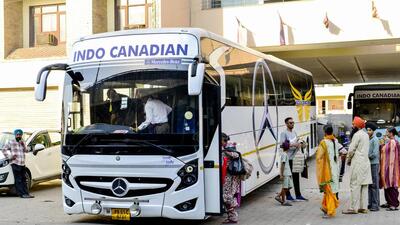 Travellers flying to Canada gather to board a bus bound for the airport in Jalandhar, Punjab on October 15, 2024. (AFP) Travellers flying to Canada gather to board a bus bound for the airport in Jalandhar, Punjab on October 15, 2024. (AFP)