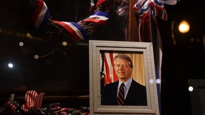 A photograph of President Jimmy Carter sits in the window of a store on the main street of his hometown on January 04, 2025, in Plains, Georgia. (Getty Images via AFP) A photograph of President Jimmy Carter sits in the window of a store on the main street of his hometown on January 04, 2025, in Plains, Georgia. (Getty Images via AFP)