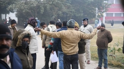 BPSC 70th Prelims Re-Exam to be held on January 4. Applicants waiting outside exam centre at Mahath Hanuman Sharn high School, in Patna. (Santosh Kumar ) BPSC 70th Prelims Re-Exam to be held on January 4. Applicants waiting outside exam centre at Mahath Hanuman Sharn high School, in Patna. (Santosh Kumar )