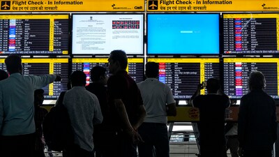 Passengers look at screens at T3 Terminal of the Indira Gandhi International Airport amid Microsoft outage, in New Delhi, Friday, July 19, 2024. (File Photo/PTI)