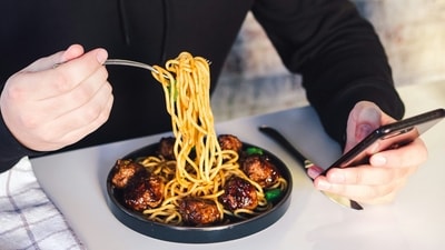 Person eating spaghetti with meatballs (unsplash) Person eating spaghetti with meatballs (unsplash)