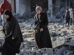 Palestinian women walk across building debris following an Israeli airstrike at the Nuseirat refugee camp in central Gaza, on Friday, Jan. 3, 2025. Photographer: Ahmad Salem/Bloomberg (Bloomberg) Palestinian women walk across building debris following an Israeli airstrike at the Nuseirat refugee camp in central Gaza, on Friday, Jan. 3, 2025. Photographer: Ahmad Salem/Bloomberg (Bloomberg)