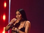 Nicki Minaj performs onstage during the MTV Video Music Awards in a black see-through embellished dress worn over matching black lingerie.&nbsp;