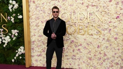 Glen Powell arrives at the 82nd Golden Globes on Sunday. (Jordan Strauss/Invision/AP)