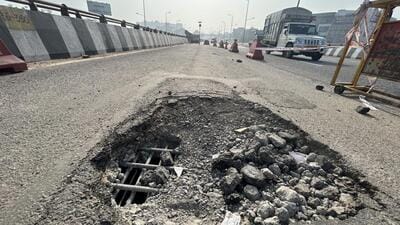 A portion of the bridge on the extreme right lane from Jaipur to Delhi side lost plaster and concrete late on Friday evening, leaving the iron bars exposed and the road underneath the flyover becoming visible due to a three by 2 feet hole. (Parveen Kumar/HT Photo)