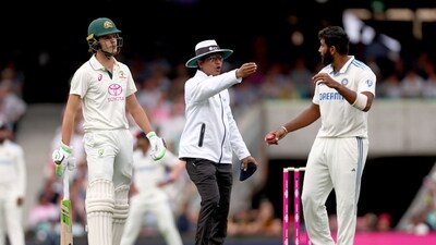 Umpire Sharfuddoula Ibne Shahid Saikat (C) gestures as he stands between Sam Konstas (L) and India's captain Jasprit Bumrah (R) during day one of the fifth Test (AFP) Umpire Sharfuddoula Ibne Shahid Saikat (C) gestures as he stands between Sam Konstas (L) and India's captain Jasprit Bumrah (R) during day one of the fifth Test (AFP)