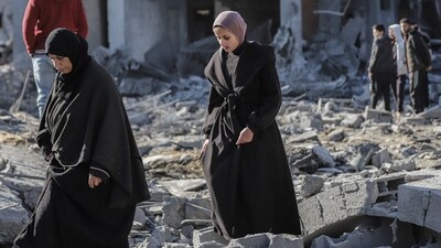 Palestinian women walk across building debris following an Israeli airstrike at the Nuseirat refugee camp in central Gaza, on Friday, Jan. 3, 2025. Photographer: Ahmad Salem/Bloomberg (Bloomberg) Palestinian women walk across building debris following an Israeli airstrike at the Nuseirat refugee camp in central Gaza, on Friday, Jan. 3, 2025. Photographer: Ahmad Salem/Bloomberg (Bloomberg)