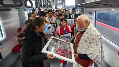 Prime Minister Narendra Modi interacts with passengers as he takes a ride on a Namo Bharat Rapid train during the inauguration of the 13 km stretch of the Delhi-Meerut Regional Rapid Transit System (RRTS) corridor between Sahibabad and New Ashok Nagar in New Delhi, on Sunday. (HT Photo)