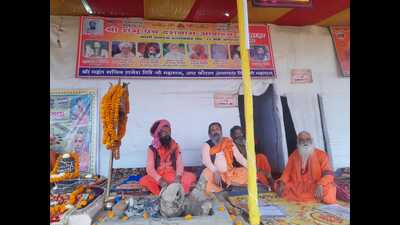Saints camping in tent city of Mahakumbh-2025 with photos of their gurus above them in Prayagraj (HT Photo) Saints camping in tent city of Mahakumbh-2025 with photos of their gurus above them in Prayagraj (HT Photo)