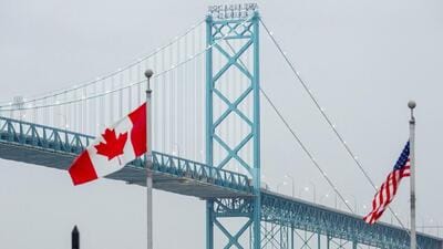 The Canadian and US flags near the Ambassador Bridge on the Canada-US border in Windsor, Ontario, Canada. (Bloomberg) The Canadian and US flags near the Ambassador Bridge on the Canada-US border in Windsor, Ontario, Canada. (Bloomberg)