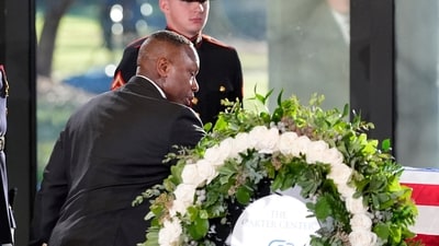 Atlanta Mayor Andre Dickens touched the casket in a gesture of respect towards former president Jimmy Carter at the Jimmy Carter Presidential Library and Museum in Atlanta (Alex Brandon/ AFP) Atlanta Mayor Andre Dickens touched the casket in a gesture of respect towards former president Jimmy Carter at the Jimmy Carter Presidential Library and Museum in Atlanta (Alex Brandon/ AFP)