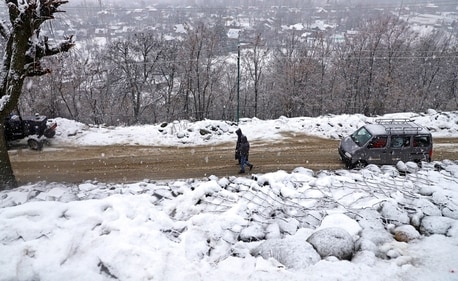 People walk amid fresh snowfall at Tangmarg area, in Baramulla district, Jammu and Kashmir, Sunday, Jan. 5, 2025. (PTI) People walk amid fresh snowfall at Tangmarg area, in Baramulla district, Jammu and Kashmir, Sunday, Jan. 5, 2025. (PTI)