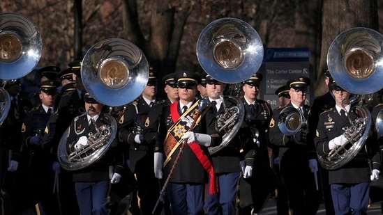 Late former US president Jimmy Carter's funeral proceedings began at the Jimmy Carter Presidential Library and Museum, with the US Army Band playing in tribute on Saturday.(Brynn Anderson/ REUTERS)