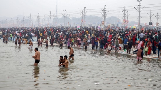 Prayagraj, Jan 05 (ANI): Devotees take a dip at the Sangam of the Ganga, the Yamuna and Saraswati (mythical) Rivers on a foggy and cold winter day, in Prayagraj on Sunday. (ANI Photo) (Ravi Prakash)