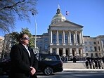 Former and current US Secret Service agents assigned to the Carter detail walked with the hearse carrying the flag-draped casket of former US President Jimmy Carter at Phoebe Sumter Medical Center in Americus, Georgia, on Saturday.