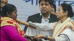 West Bengal chief minister Mamata Banerjee consoles a fisherman's wife whose husband had jumped in the water before arrest in Bangladesh and has been missing since then, during the felicitation of fishermen who were recently released from Bangladesh jail, at Sagar Island in South 24 Parganas district on Monday. (PTI)