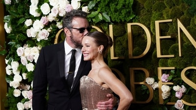 Dax Shepard, left, and Kristen Bell arrive at the 82nd Golden Globes. (Jordan Strauss/Invision/AP)