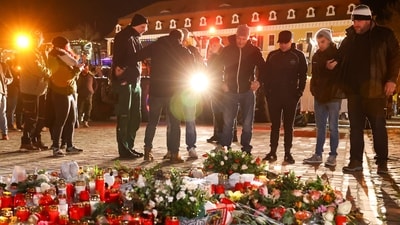 People lay flowers in the cathedral square of Magdeburg, Germany, in remembrance for the victims of the attack at a Christmas market on Dec. 20, 2024. (AP/Peter Gercke)