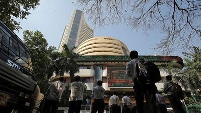 Stock market crash: People look at a screen displaying the Sensex results on the facade of the Bombay Stock Exchange (BSE) building in Mumbai. (Reuters)