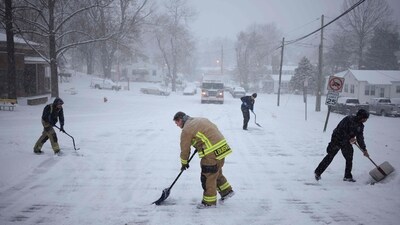 Emergency personnel clear up snow on the road. Cold air will likely grip the country's eastern half as far south as Georgia, with parts of the East Coast experiencing freezing temperatures and lows dipping into the single digits in some areas. (AFP) Emergency personnel clear up snow on the road. Cold air will likely grip the country's eastern half as far south as Georgia, with parts of the East Coast experiencing freezing temperatures and lows dipping into the single digits in some areas. (AFP)