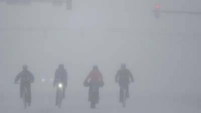 A group of cyclists make their way through downtown Wichita, Kansas, during a severe winter storm on Sunday, January. 5, 2025. A large swath of the U.S., across the Midwest to the East Coast, is experiencing a major Winter storm. (AP) A group of cyclists make their way through downtown Wichita, Kansas, during a severe winter storm on Sunday, January. 5, 2025. A large swath of the U.S., across the Midwest to the East Coast, is experiencing a major Winter storm. (AP)
