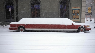 A limousine covered in heavy snow (AFP) A limousine covered in heavy snow (AFP)