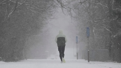 A person runs down a trail during a winter storm on Sunday, January. 5, 2025, in Cincinnati. (AP) A person runs down a trail during a winter storm on Sunday, January. 5, 2025, in Cincinnati. (AP)