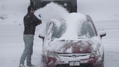 A person dusts snow off of a car during a winter storm, Sunday, Jan. 5, 2025, in Cincinnati. About 63 million people in the central and southern US are on alert for a 'heaviest' possible winterstorm. (AP) A person dusts snow off of a car during a winter storm, Sunday, Jan. 5, 2025, in Cincinnati. About 63 million people in the central and southern US are on alert for a 'heaviest' possible winterstorm. (AP)
