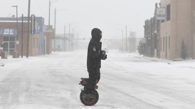 A man on a one-wheel electric scooter makes his way through downtown Wichita, Kansas, during a severe winter storm on Sunday, January 5, 2025. About 65 million people are on high alert for ‘heaviest possible’ snowfall. (AP) A man on a one-wheel electric scooter makes his way through downtown Wichita, Kansas, during a severe winter storm on Sunday, January 5, 2025. About 65 million people are on high alert for ‘heaviest possible’ snowfall. (AP)