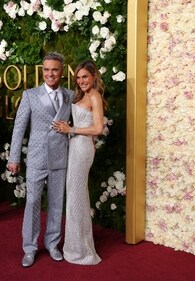Robbie Williams and Ayda Field in a shimmery matching outfit. Robbie Williams and Ayda Field in a shimmery matching outfit.