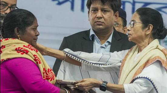 West Bengal chief minister Mamata Banerjee consoles a fisherman's wife whose husband had jumped in the water before arrest in Bangladesh and has been missing since then, during the felicitation of fishermen who were recently released from Bangladesh jail, at Sagar Island in South 24 Parganas district on Monday. (PTI)
