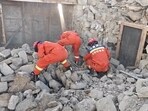 Rescue teams look through rubble in the aftermath of an earthquake in a location given as Shigatse City, Tibet.
