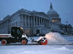 WASHINGTON, DC - JANUARY 06: Crews work before dawn to clear snow East Front Plaza of the U.S. Capitol as a winter storm slams into the nation's capital on January 06, 2025 in Washington, DC.