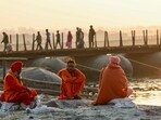 Sadhus rest on the river banks next to a floating pontoon bridge across the river Ganges as they take part in the Juna Akhara procession, ahead of the Maha Kumbh Mela festival in Prayagraj on December 14, 2024 Sadhus rest on the river banks next to a floating pontoon bridge across the river Ganges as they take part in the Juna Akhara procession, ahead of the Maha Kumbh Mela festival in Prayagraj on December 14, 2024