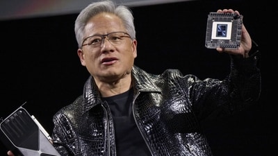 Jensen Huang, co-founder and chief executive officer of Nvidia Corp., speaks while holding the company's new GeForce RTX 50 series graphics cards and a Thor Blackwell robotics processor during the 2025 CES event in Las Vegas, Nevada, US, on Monday, Jan. 6, 2025. Huang announced a raft of new chips, software and services, aiming to stay at the forefront of artificial intelligence computing. (Bridget Bennett/Bloomberg) Jensen Huang, co-founder and chief executive officer of Nvidia Corp., speaks while holding the company's new GeForce RTX 50 series graphics cards and a Thor Blackwell robotics processor during the 2025 CES event in Las Vegas, Nevada, US, on Monday, Jan. 6, 2025. Huang announced a raft of new chips, software and services, aiming to stay at the forefront of artificial intelligence computing. (Bridget Bennett/Bloomberg)