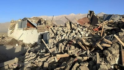 In this photo released by Xinhua News Agency, people stand amidst damaged houses in the aftermath of an earthquake in Tonglai Village, Changsuo Township of Dingri in Xigaze, southwestern China's Tibet Autonomous Region on Tuesday. ((Xinhua via AP)) In this photo released by Xinhua News Agency, people stand amidst damaged houses in the aftermath of an earthquake in Tonglai Village, Changsuo Township of Dingri in Xigaze, southwestern China's Tibet Autonomous Region on Tuesday. ((Xinhua via AP))