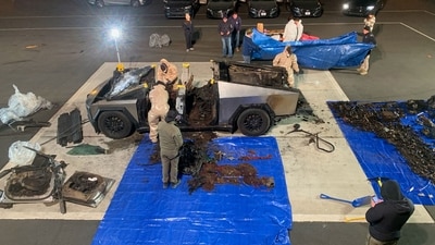 Investigators inspect the burned Tesla Cybertruck, which the police say was driven by Matthew Livelsberger, 37, an active-duty Army soldier from Colorado Springs, after it exploded in front of the Trump International Hotel in Las Vegas. (REUTERS)