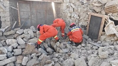 Rescue teams look through rubble in the aftermath of an earthquake in a location given as Shigatse City, Tibet. (Reuters)