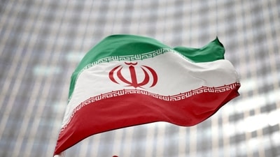 Iranian flag flies in front of the UN office building, (REUTERS)