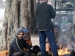 Delhi weather: People sitting around a bonfire to warm themselves by fire on cold winter morning at Ram Lila Maidan in New Delhi. Delhi weather: People sitting around a bonfire to warm themselves by fire on cold winter morning at Ram Lila Maidan in New Delhi.