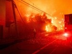 Firefighters battle the Palisades Fire in the Pacific Palisades neighborhood of Los Angeles, California. 