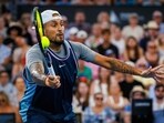 Nick Kyrgios of Australia and Novak Djokovic of Serbia (not pictured) hit a return against Michael Venus of New Zealand and Nikola Mektic of Croatia during their men's doubles match at the Brisbane International tennis tournament