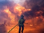A firefighter battles the Palisades Fire as it burns during a windstorm on the west side of Los Angeles, California, U.S. January 7, 2025. REUTERS/Ringo Chiu